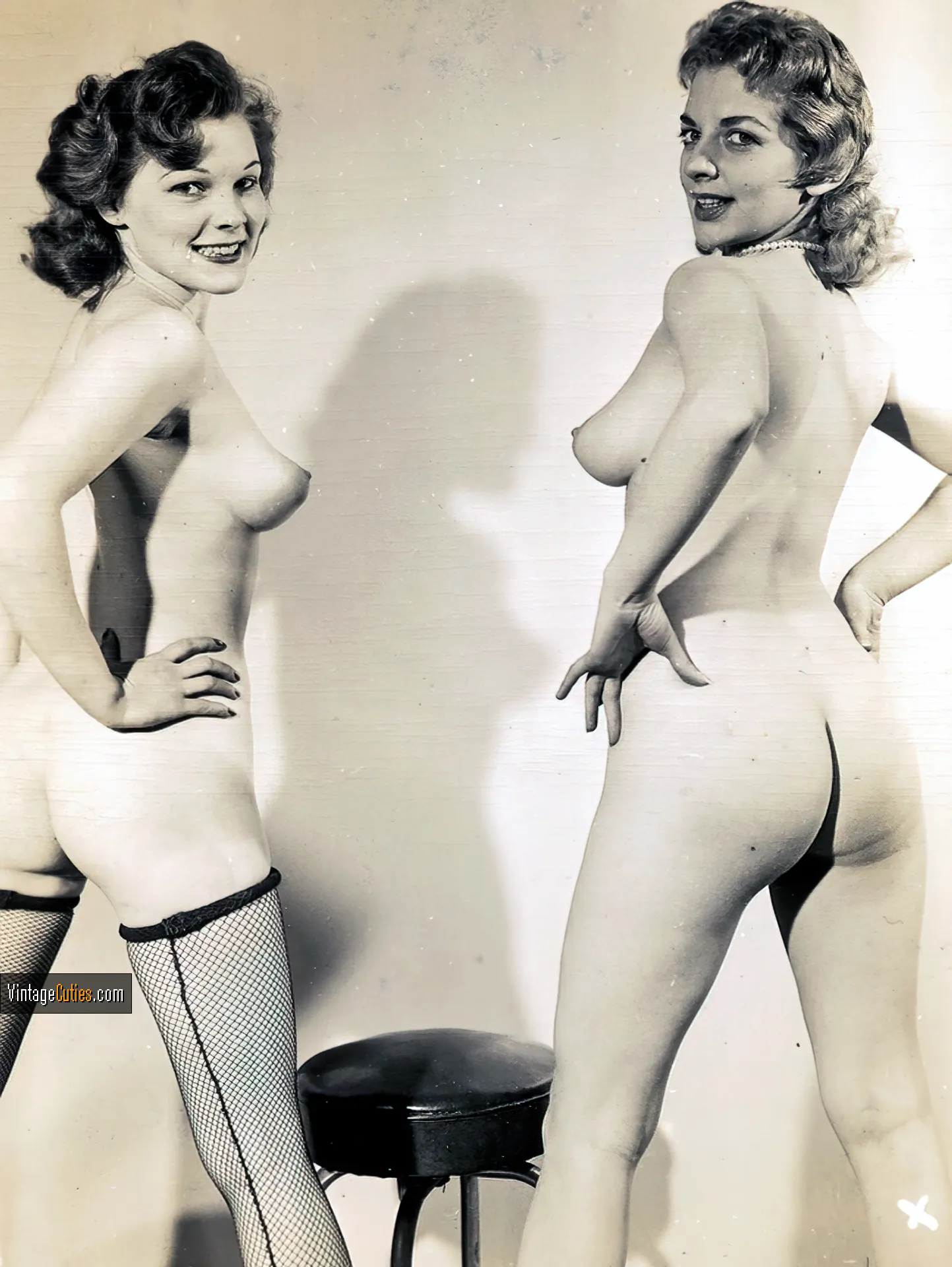 Two glamorous looking vintage chicks show off their bare asses