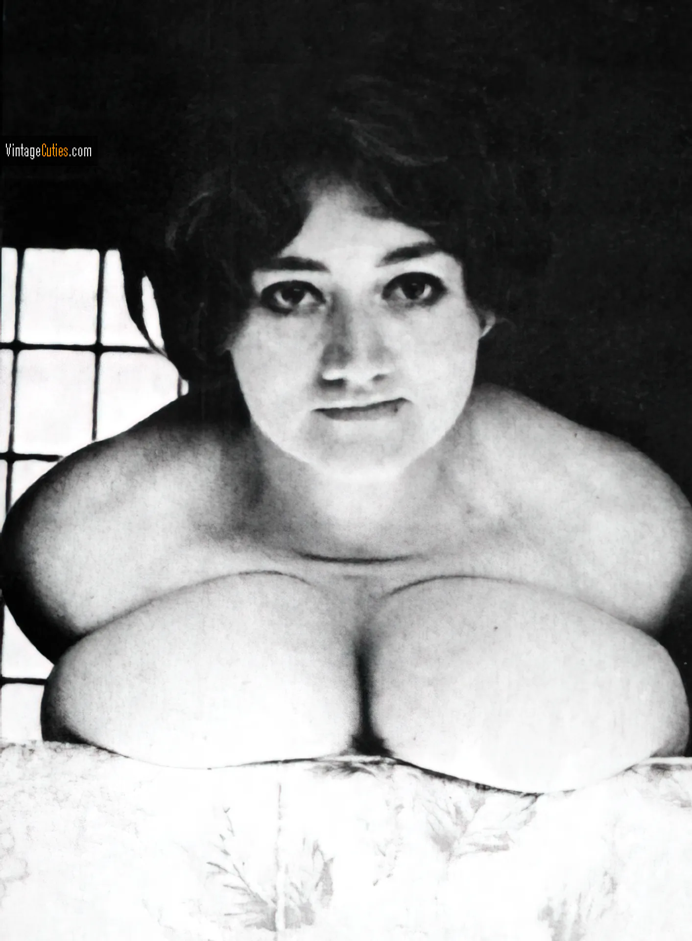 Busty Russell lying on her chubby soft tits