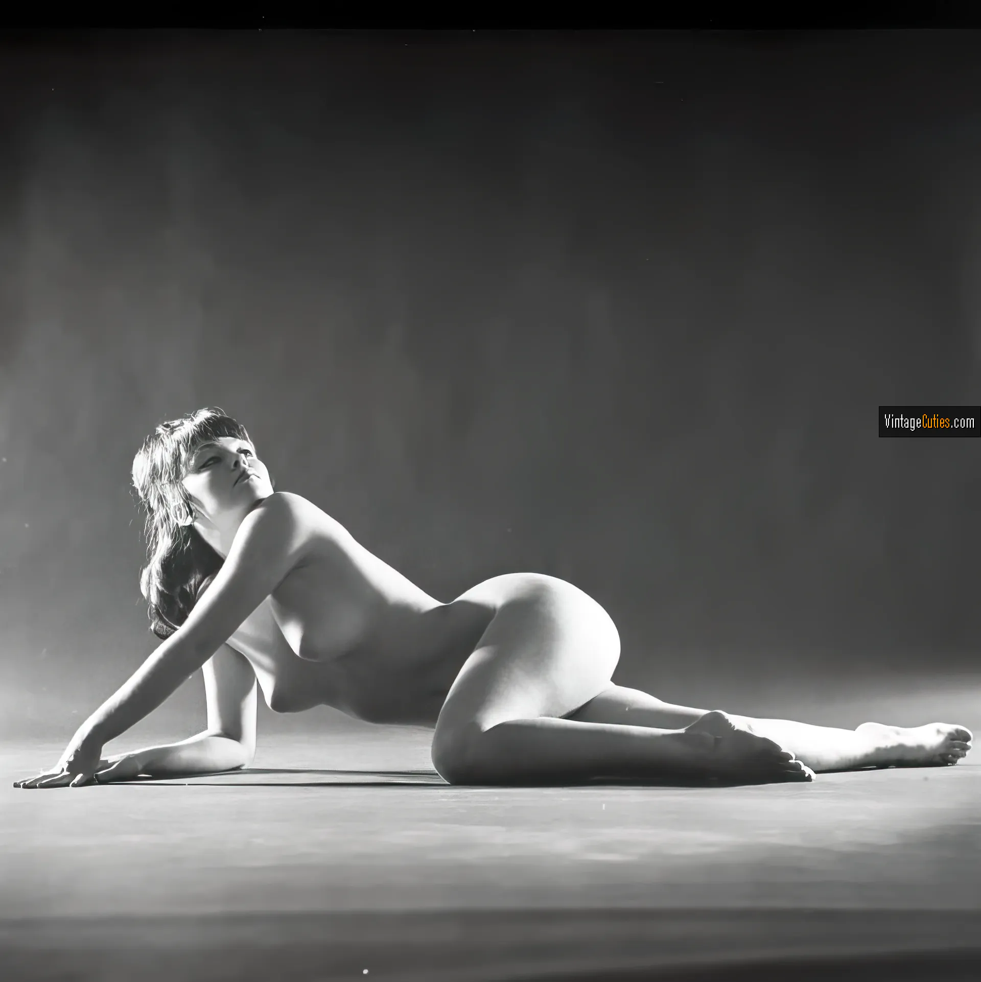 Mickey Jines posing naked on the floor with silky titties